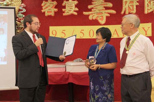 Asher presenting NYC Comptroller John Liu's commendation to Kee and Gene