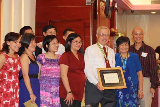 Rebecca, James, Shirley, T, Denise, Kevin, Juliet, Gene, Kee, and Gary showing our guests the President's award in a gold frame from our children and their spouses.