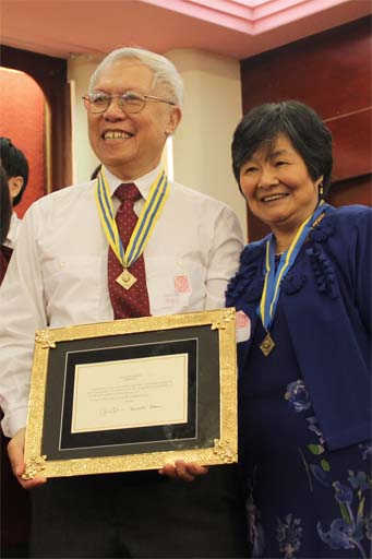 Gene and Kee with Obama award and gold frame from children and spouses